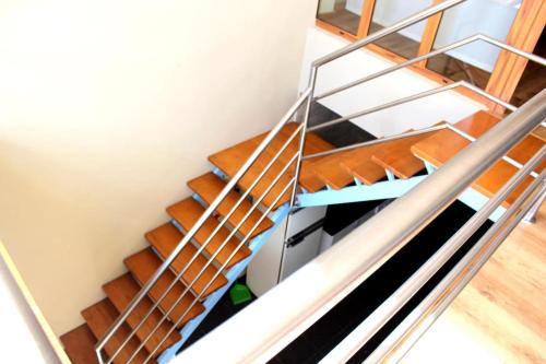 a metal staircase with wooden treads in a room at Casa da Avo Maria - 2 in Podence