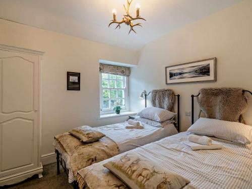1 dormitorio con 2 camas y lámpara de araña en 3 Bed in Lakeside 94925, en Lake Side