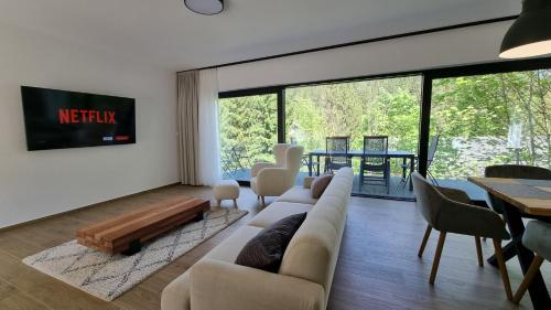 a living room with a couch and a table at Chalets Hrabovo in Ružomberok