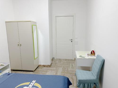 a bedroom with a bed and a desk and a chair at Venice mestre sweet home in Marghera