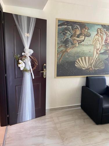 a room with a door with a curtain and a painting at Selefkos Palace in Igoumenitsa
