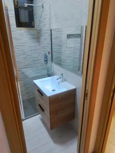 a bathroom with a sink and a shower with a mirror at Casa Materdomini in Brindisi