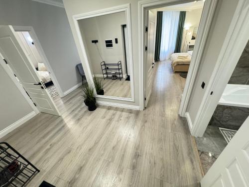 a hallway of a home with a large mirror at Central Beautiful Apartment with Parking in Chişinău