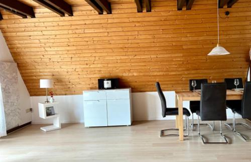 a room with a table and chairs and a wooden wall at Ferienhaus Maria in Nagel