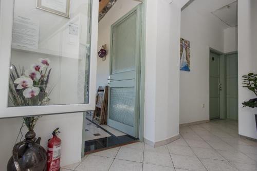 a hallway with a glass door with flowers in it at Apartmani Zukic in Risan
