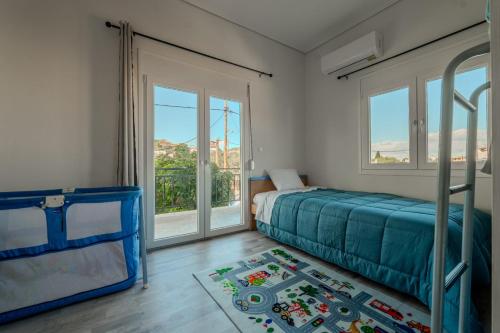a bedroom with a bed and a large window at Anastasia's lemon garden in Artemida
