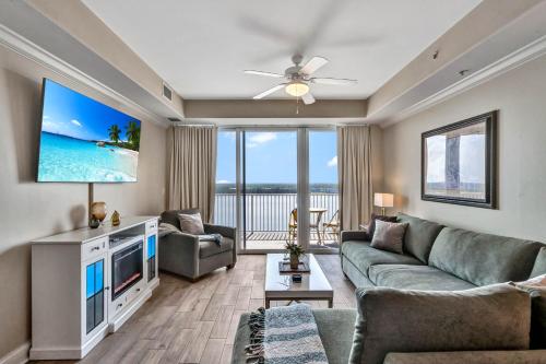 a living room with a couch and a tv at Sunshine Oasis - Orlando Lakefront Luxury in Orlando