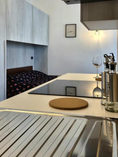 a kitchen with a counter top with a wine glass at Casa Stile Libero 40 Arcore FS-GP Monza-Milano-Lecco in Arcore