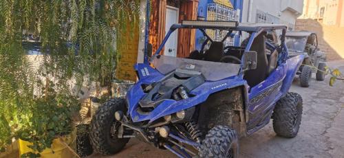a blue four wheeled vehicle parked next to a building at Atlas Room in Midelt