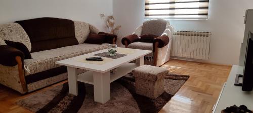 a living room with a couch and a table at Apartman stan na dan B&B in Lukavica