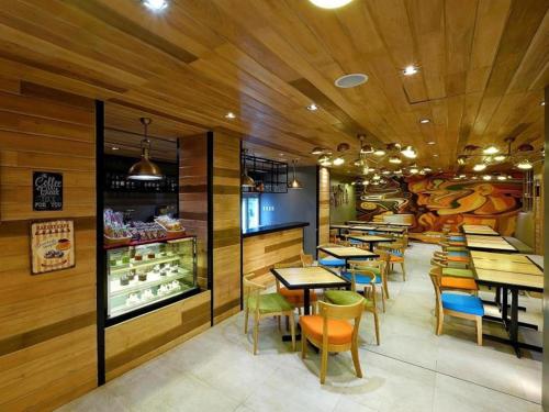 a restaurant with wooden walls and tables and chairs at Golden Prince Hotel & Suites in Cebu City