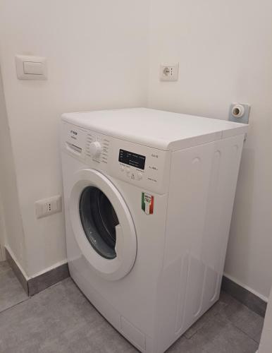 a white washing machine sitting in a room at Casa Vacanze Aversa centro 2 in Aversa