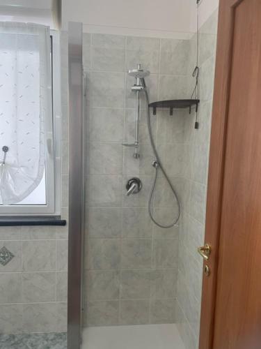 a bathroom with a shower with a glass door at NORA House in Savona
