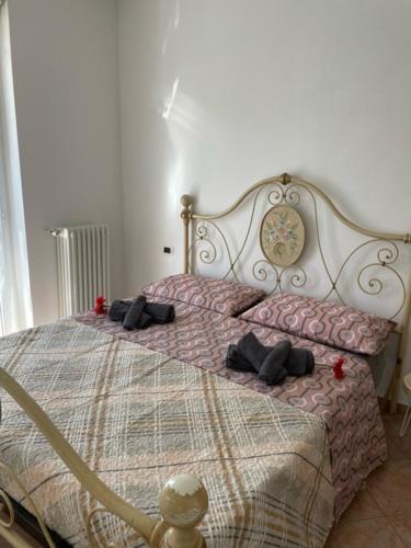 a bedroom with a large bed with pillows on it at NORA House in Savona