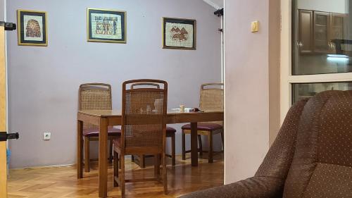 a dining room with a table and chairs at Второй этаж in Voždovac