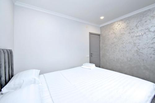 a white bedroom with a white bed in it at 1# Guest House in Pʼarakʼar