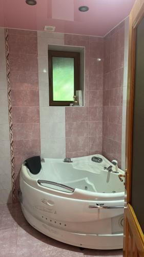 a bath tub in a bathroom with a window at Nice House in Ijevan