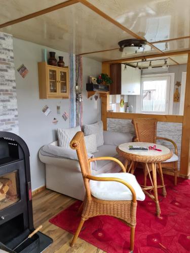 a living room with a couch and a table at Kleine Ferienwohnung in der Natur in Rheinsberg