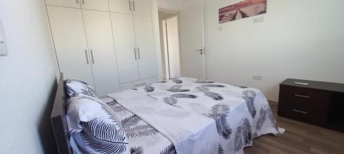 a bedroom with a bed with a blanket on it at Trendy Holiday Villa 34 Larnaca, Pyla in Pyla