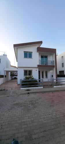 a large white house with a large driveway at Trendy Holiday Villa 34 Larnaca, Pyla in Pyla