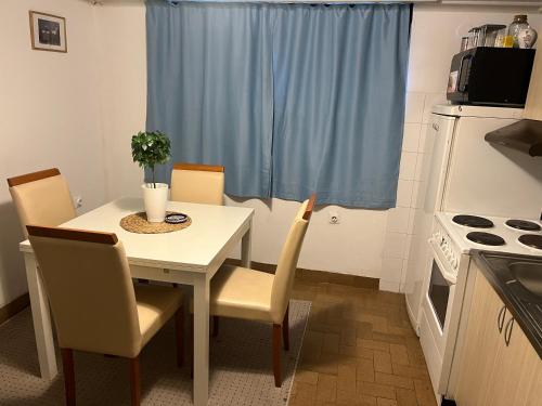 a small kitchen with a white table and chairs at İstanbul apartment 1 in Belgrade
