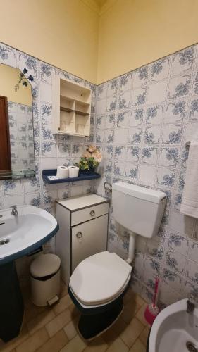 a bathroom with a white toilet and a sink at Santa Isabel in Portimão