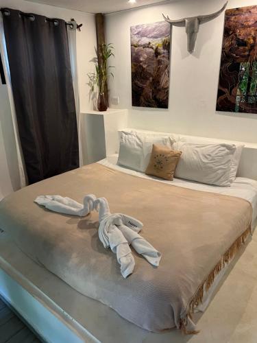 a bedroom with a bed with two swans on it at Hostel-Island Paradise, Saboga Lodge and Villa Noelia in Panama City