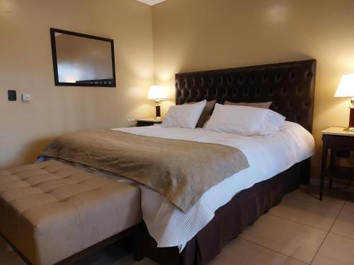 a bedroom with a large bed with a large headboard at Comfortable Modern Apartment in Buenos Aires