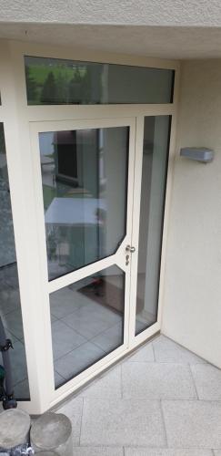 a sliding glass door on a building with at Moderne Gästesuite in Luzern