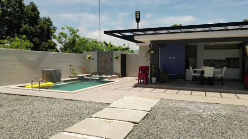 a backyard with a swimming pool and a house at Villa Ybelis Paradise in Concepción de La Vega