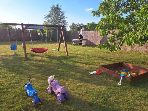a yard with toys in the grass with a swing at Villa Sunset in Palić