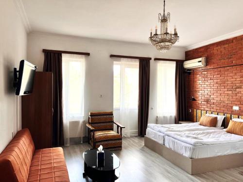 a bedroom with a large bed and a couch at Tbil Inn Hotel in Tbilisi City