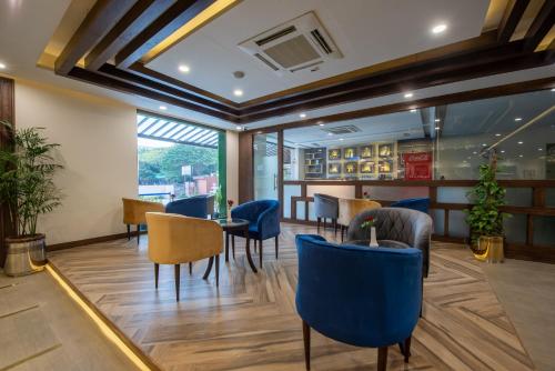 a restaurant with blue chairs and tables at Legend Hotel Islamabad in Islamabad
