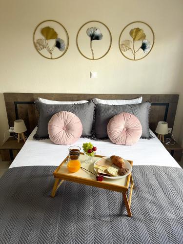 a tray of food on a bed with a tray of food at Armonia Guest House in Nea Roda