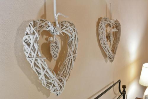 two heart decorations hanging on a wall at Da Titta in Pitigliano