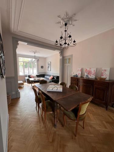 une salle à manger avec une table et des chaises et un salon dans l'établissement Villa du casino, à Dunkerque