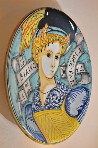 a plate with a picture of a mermaid at Da Titta in Pitigliano