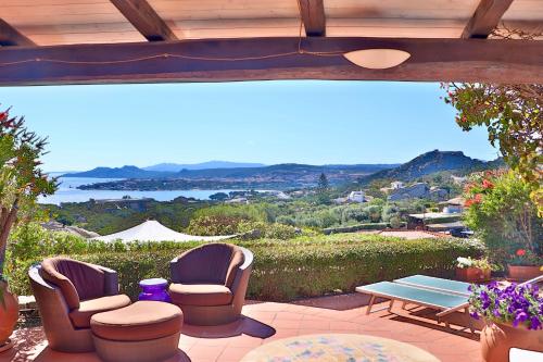 a patio with two chairs and a table at Cottage Dolcevita by KlabHouse in Palau