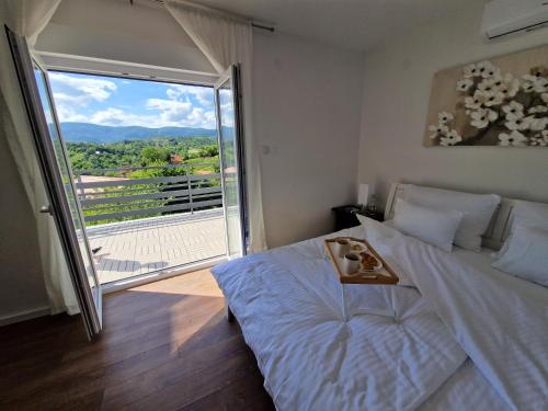 a bedroom with a large bed and a large window at Villa Otto - Private Pool & Garden in Zagreb