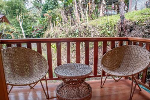 two chairs and a table on a porch at La Casa de Cecilia Mindo in Mindo