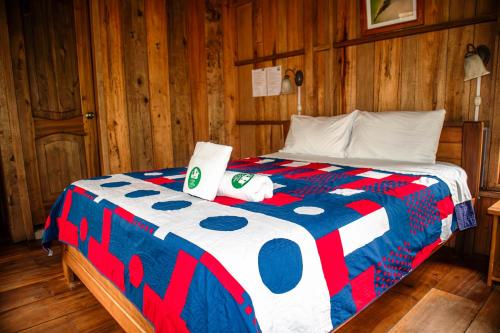 a bedroom with a bed with a laptop on it at La Casa de Cecilia Mindo in Mindo