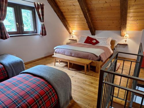 a bedroom with two beds in a attic at Locanda del Sasso Rooms in Crodo