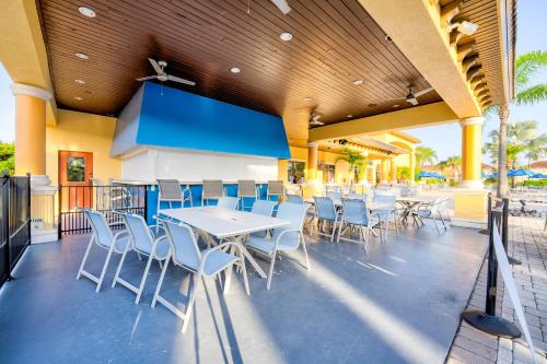 a patio with tables and chairs on the beach at Beautiful Townhome just 8 miles from Disney in Kissimmee