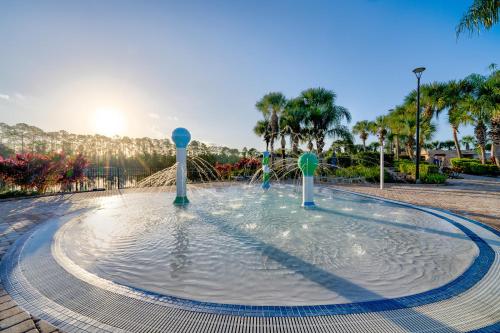 a pool of water with a fountain at Beautiful Townhome just 8 miles from Disney in Kissimmee