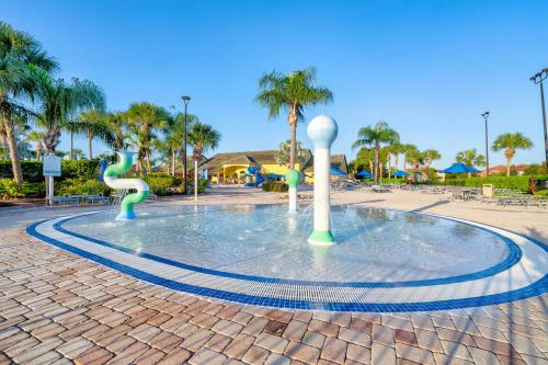 a fountain in a park with a water slide at Beautiful Townhome just 8 miles from Disney in Kissimmee