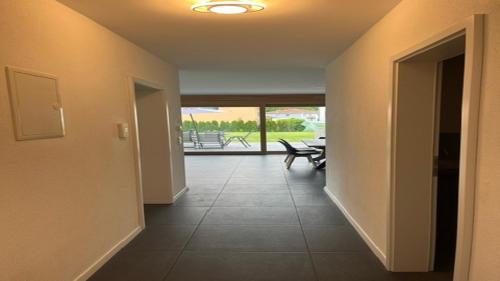 a hallway with a view of a room with a table at Moderne Ferienwohnung Sonnenbühl in Singen