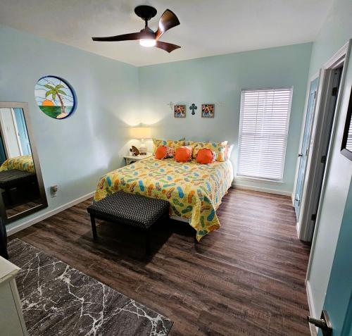 a bedroom with a bed and a ceiling fan at Aly-Kats Flip Flop Flat in Rockport