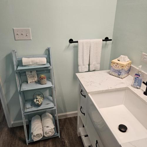 a bathroom with a sink and a counter with towels at Aly-Kats Flip Flop Flat in Rockport