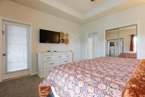 a bedroom with a bed and a flat screen tv at Golf View - Elevator Accessible - Center Of Branson - FREE TICKETS INCLUDED - RL8-11A in Branson