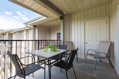 a patio with a table and chairs on a balcony at Golf View - Elevator Accessible - Center Of Branson - FREE TICKETS INCLUDED - RL8-11A in Branson